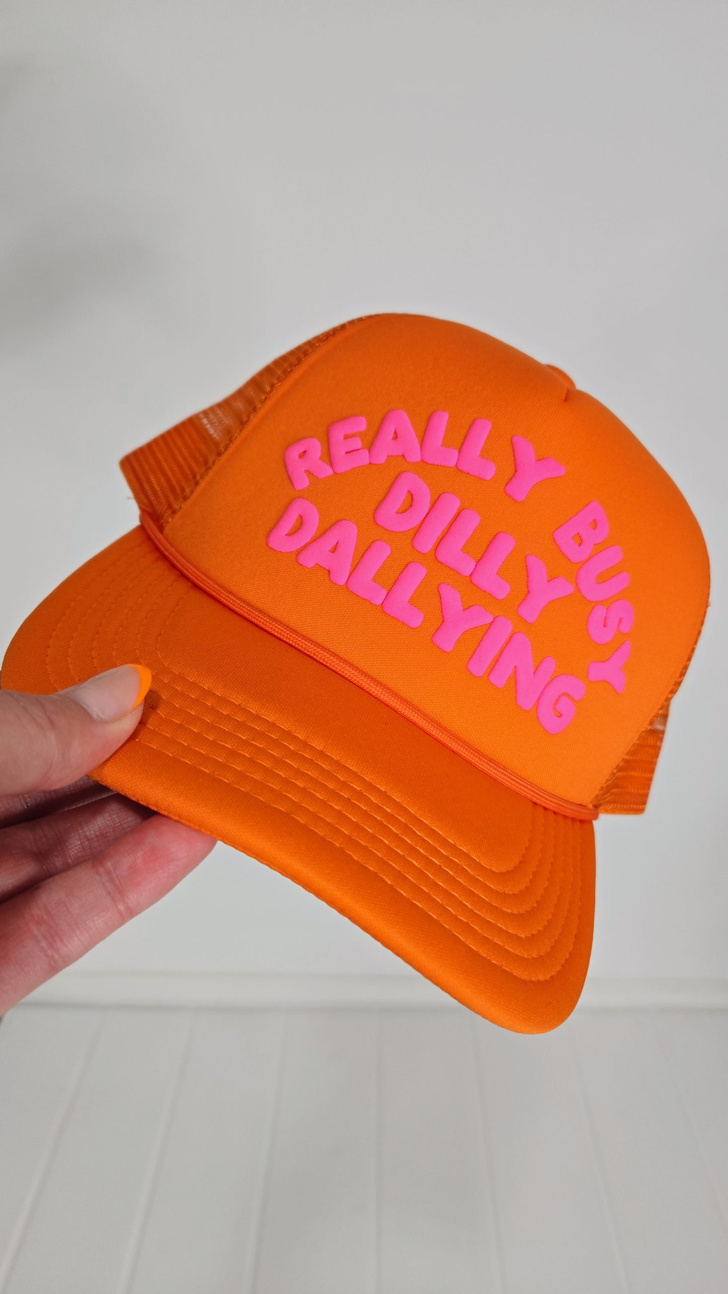 Orange Really Busy Dilly Dallying Trucker Hat "Brightyn"